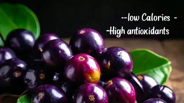 Dark purple Jamun fruits on a plate.